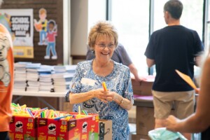 photo of volunteer at 2023 school supply drive packing school supplies
